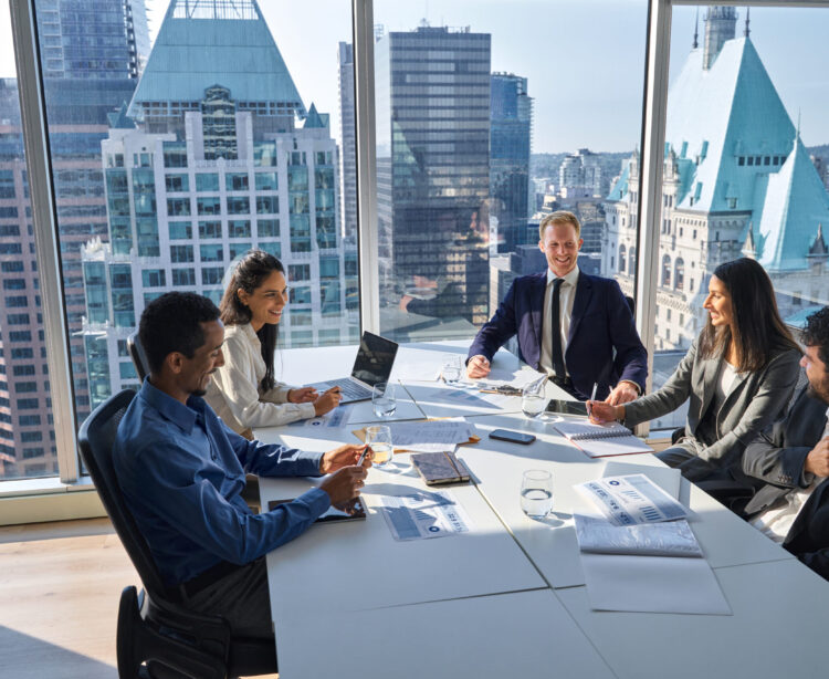 International happy professional business team consulting at group meeting. Multicultural busy coworkers working together in teamwork discussing project managing work plan in office board room.